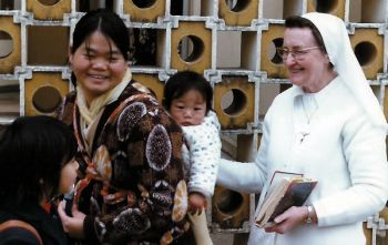 Sr. Damien with a mother and child at the Caritas Center in Fanling.