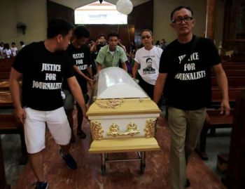 Filipino journalists escort the coffin of slain news reporter Alex Balcoba during his funeral in metro Manila, Philippines June 1, 2016.